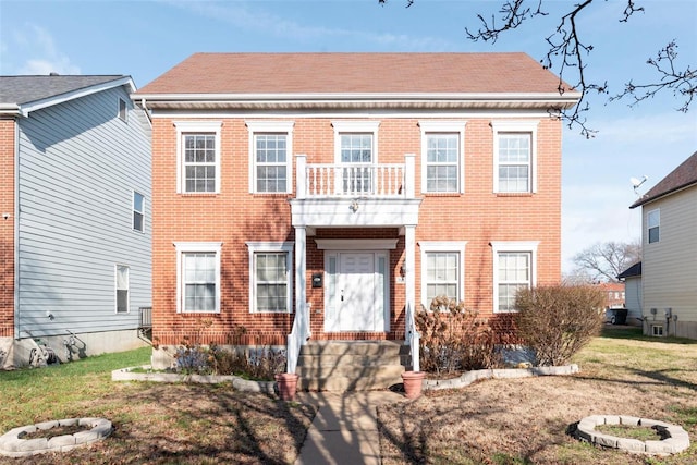 colonial house with a balcony and an outdoor fire pit