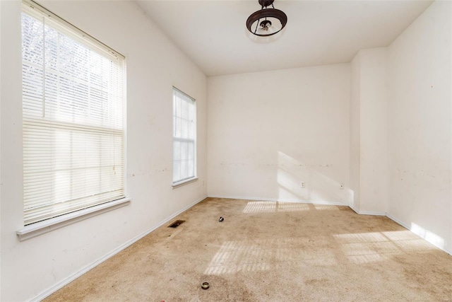 unfurnished room featuring light colored carpet