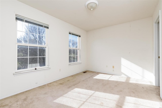 carpeted empty room featuring plenty of natural light