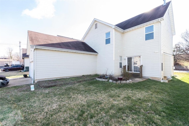 rear view of property featuring a yard