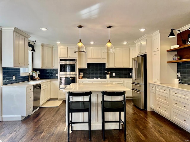 kitchen featuring pendant lighting, a center island, stainless steel appliances, and a breakfast bar area