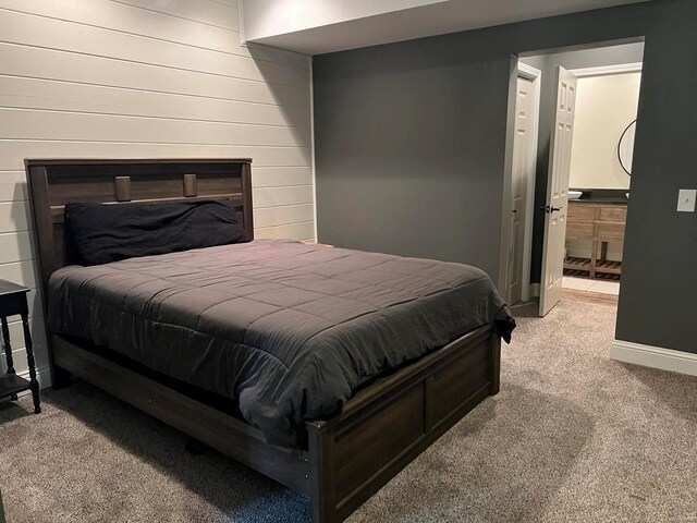 carpeted bedroom featuring ensuite bath