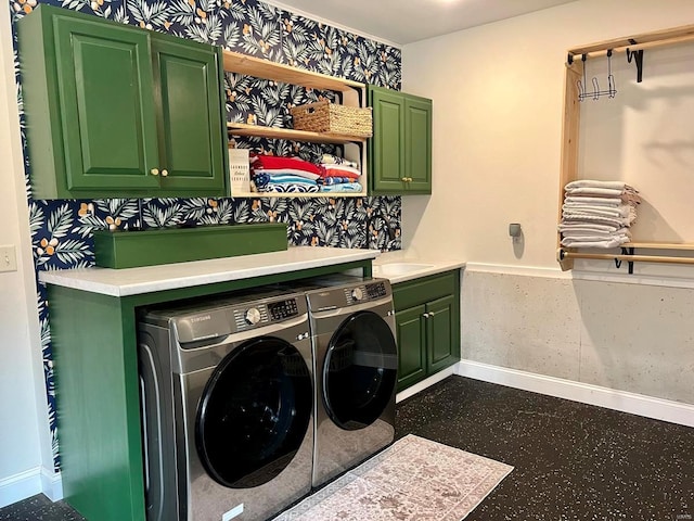 washroom featuring washing machine and clothes dryer and cabinets