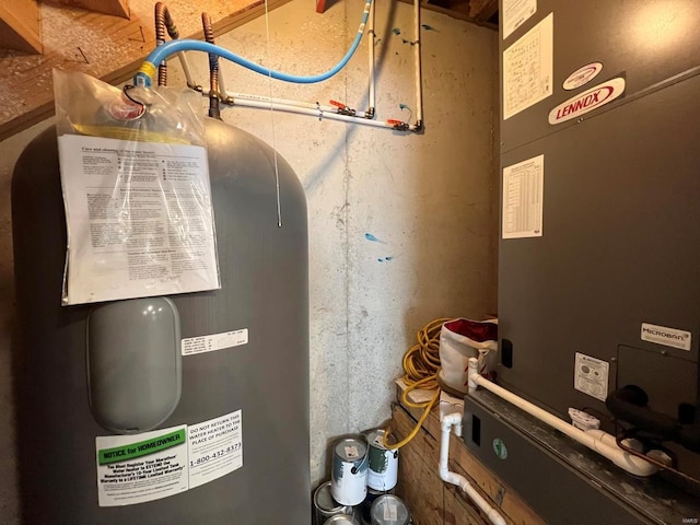 utility room with heating unit and water heater