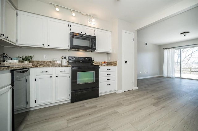 kitchen with white cabinets, light wood-type flooring, dark stone countertops, and black appliances