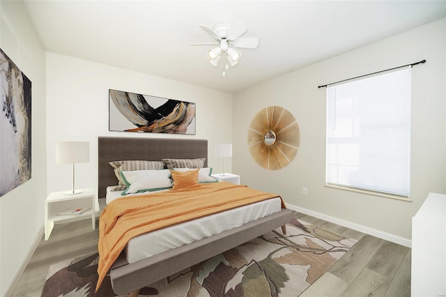 bedroom with light wood-type flooring and ceiling fan