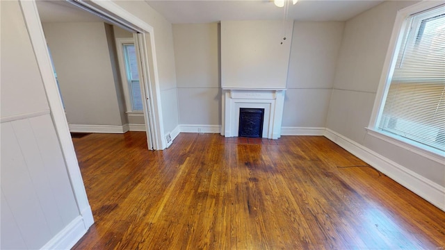 unfurnished living room featuring dark wood-type flooring