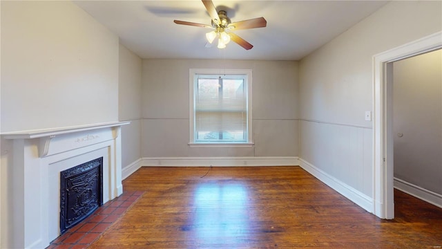 unfurnished living room with ceiling fan, dark hardwood / wood-style floors, and a fireplace