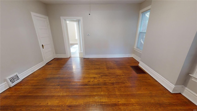 empty room featuring dark wood-type flooring