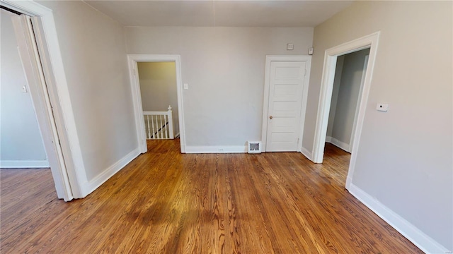 empty room with dark hardwood / wood-style flooring