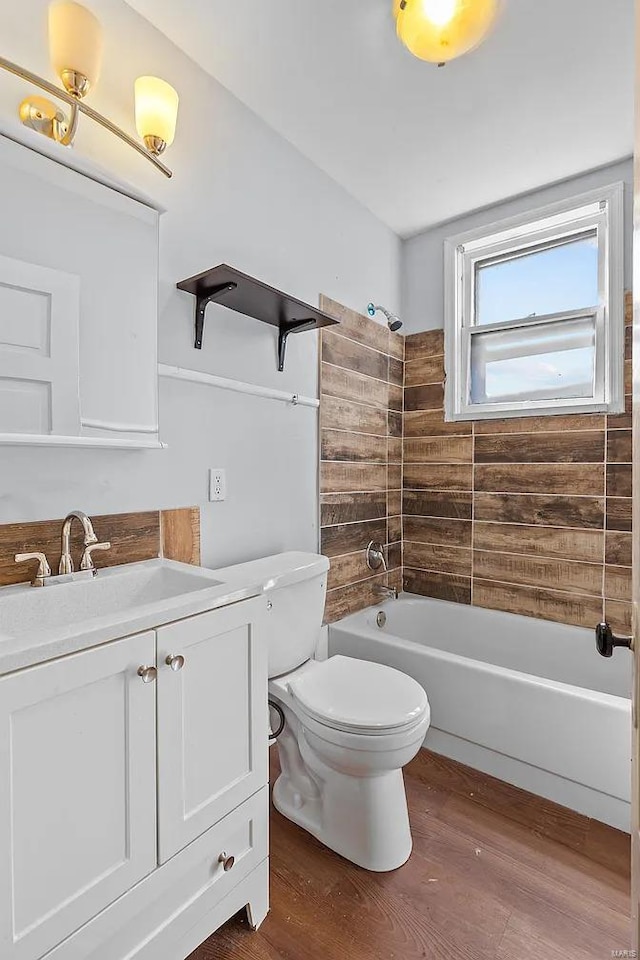 full bathroom featuring vanity, wood-type flooring, tub / shower combination, and toilet