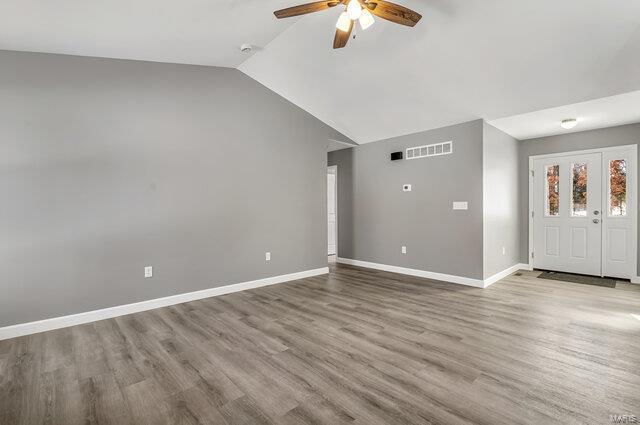 interior space with vaulted ceiling, ceiling fan, and light hardwood / wood-style floors