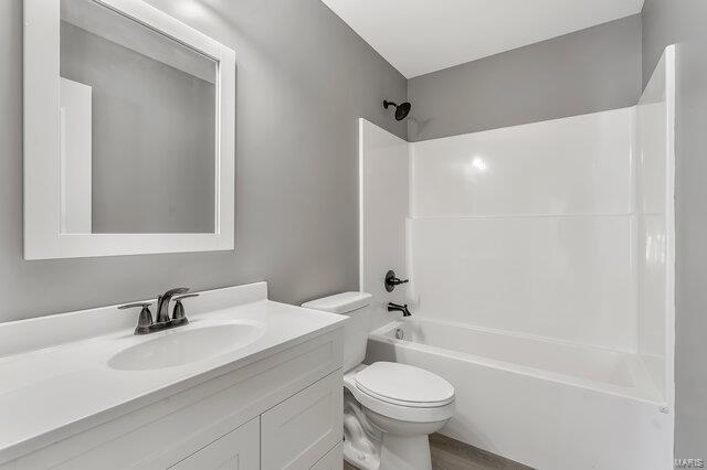 full bathroom with toilet, tub / shower combination, and vanity