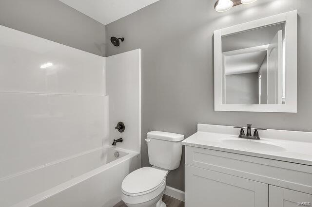 full bathroom featuring toilet, vanity, and shower / bathing tub combination