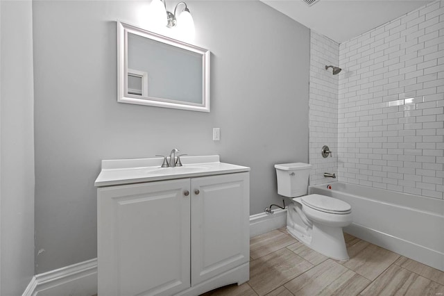 full bathroom with vanity, toilet, and tiled shower / bath