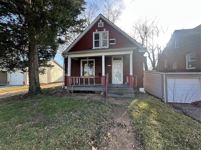 bungalow featuring covered porch and a garage