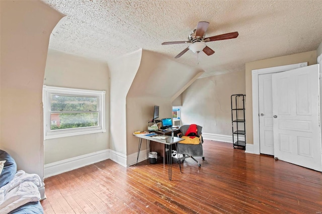 home office with hardwood / wood-style flooring, ceiling fan, lofted ceiling, and a textured ceiling