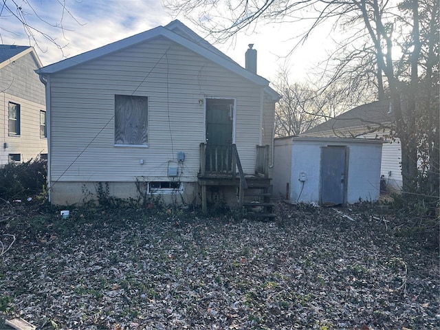 back of property with a storage unit