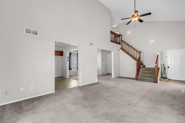 unfurnished living room featuring light carpet, high vaulted ceiling, and ceiling fan