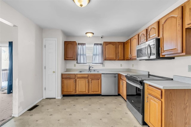 kitchen with sink and appliances with stainless steel finishes