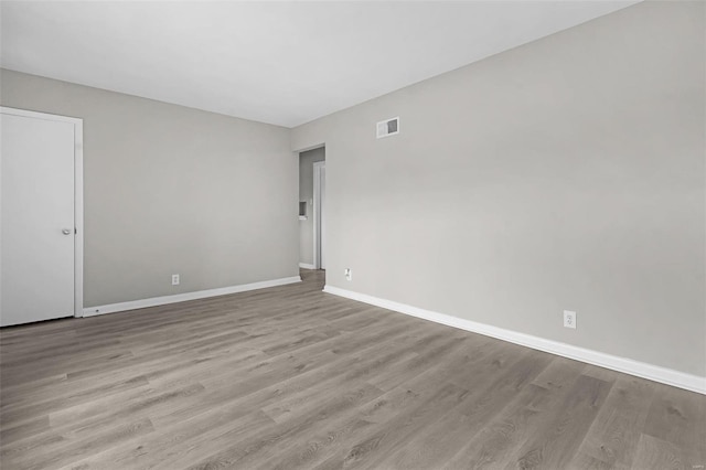 empty room with light hardwood / wood-style flooring