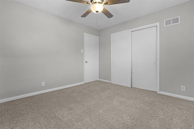 unfurnished bedroom featuring ceiling fan, carpet floors, and a closet