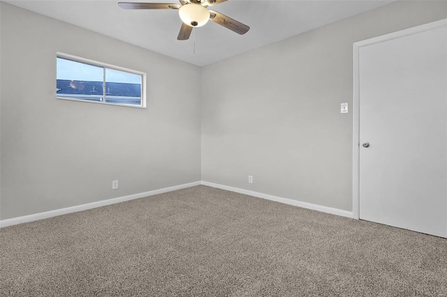 carpeted spare room with ceiling fan