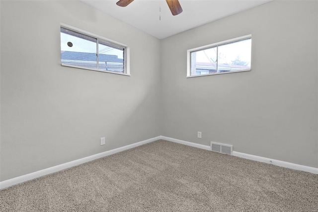 unfurnished room with carpet flooring, ceiling fan, and a healthy amount of sunlight