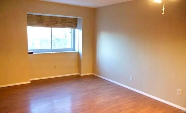 spare room featuring hardwood / wood-style floors