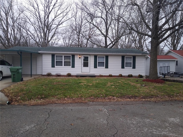 ranch-style home with a carport and a front lawn