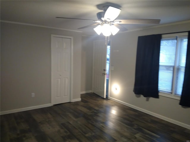 spare room featuring dark hardwood / wood-style flooring, ceiling fan, and ornamental molding