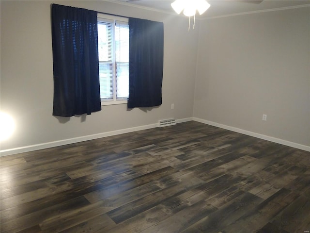 empty room with ceiling fan and dark hardwood / wood-style flooring