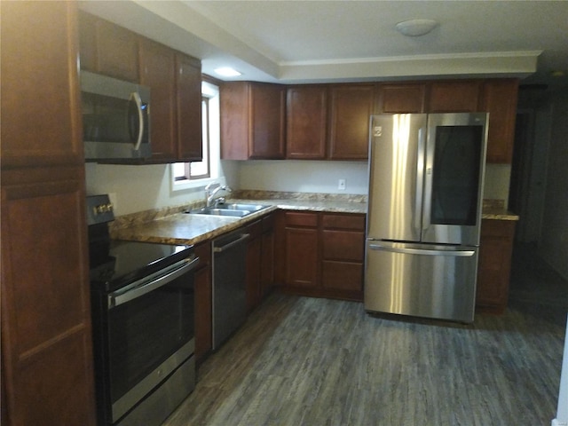 kitchen featuring dark hardwood / wood-style flooring, stainless steel appliances, and sink