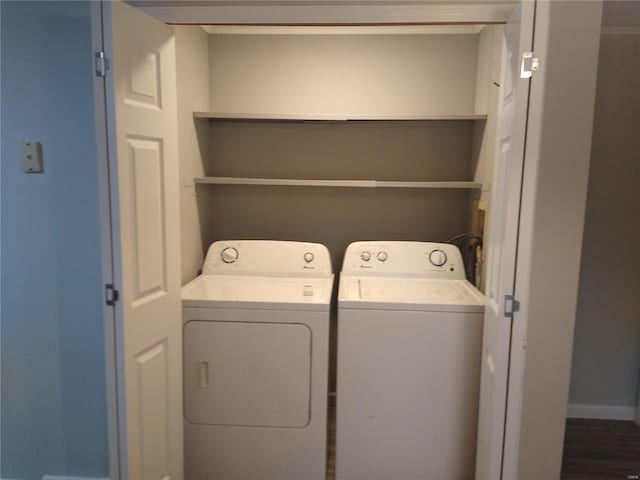 washroom featuring washing machine and clothes dryer and dark hardwood / wood-style flooring