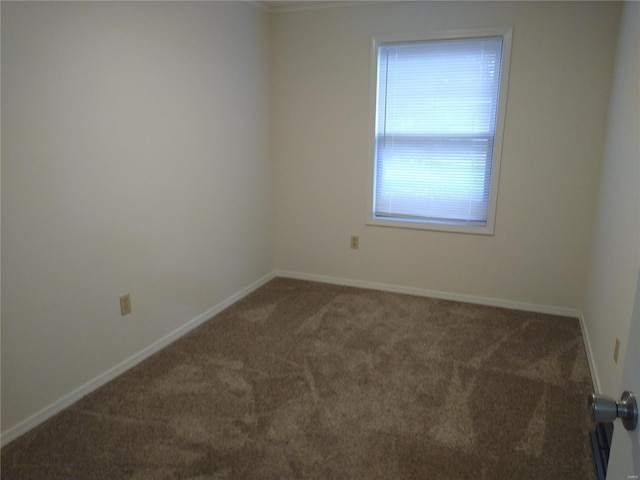 unfurnished room with dark colored carpet