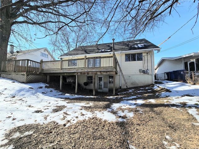 snow covered property with a deck