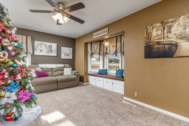 carpeted living room with ceiling fan