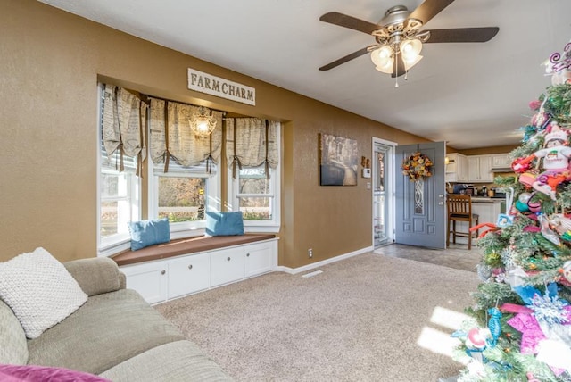 carpeted living room with ceiling fan