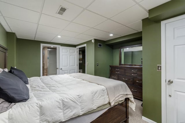 carpeted bedroom with a paneled ceiling