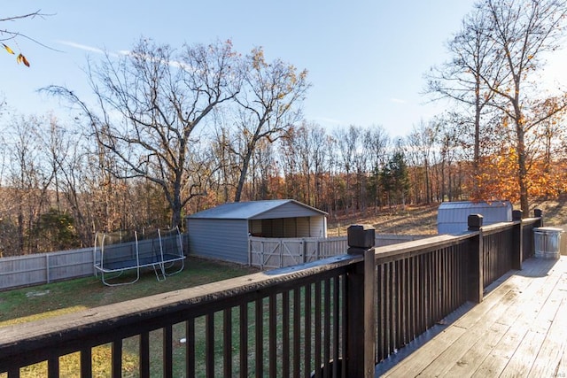 deck with a trampoline and a storage shed