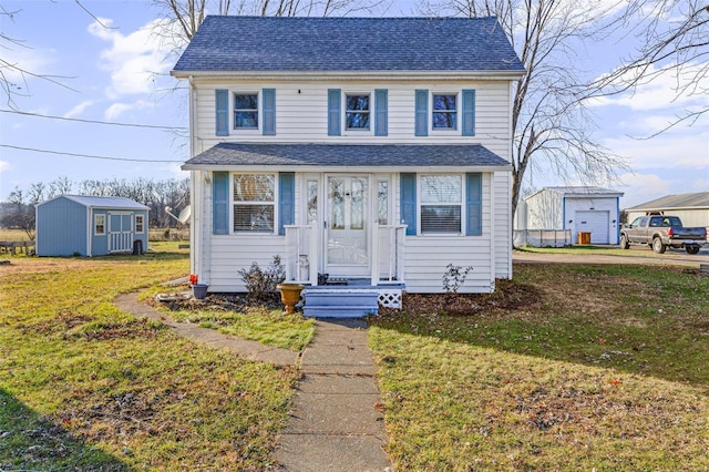 view of front of house featuring a storage unit and a front lawn