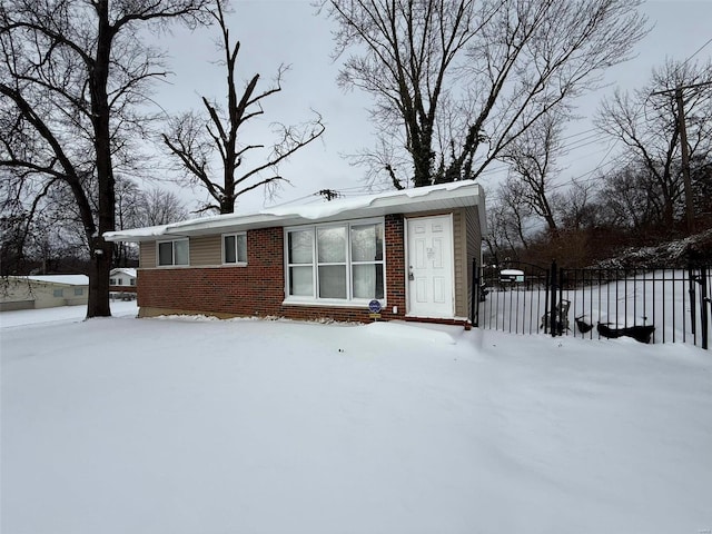 view of snow covered back of property