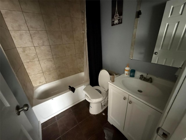 full bathroom with tiled shower / bath, tile patterned floors, vanity, and toilet