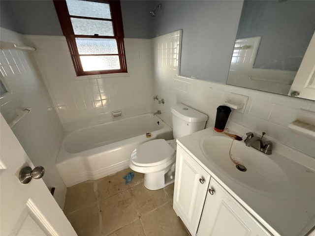 full bathroom with tiled shower / bath combo, tile patterned floors, toilet, vanity, and tile walls