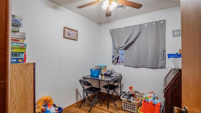 recreation room featuring ceiling fan and light hardwood / wood-style flooring