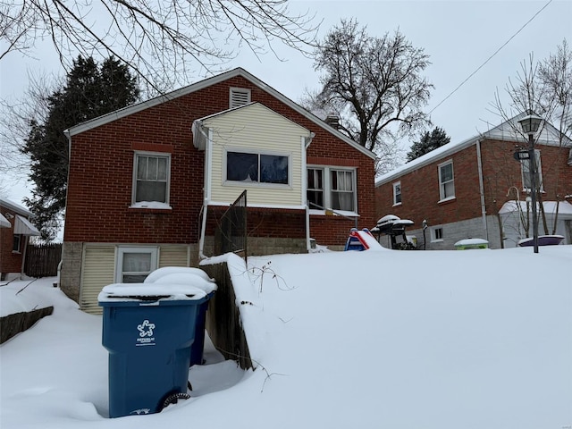 view of snow covered rear of property