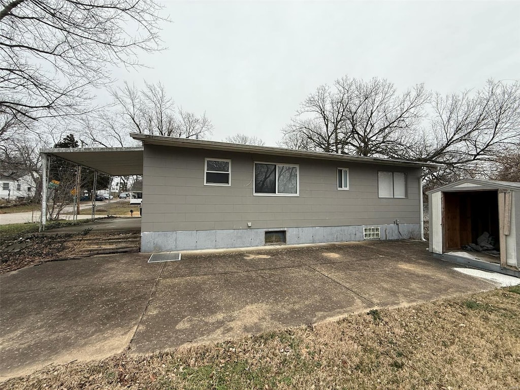 view of home's exterior featuring a carport and a shed