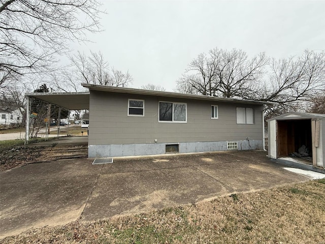 view of home's exterior featuring a carport and a shed