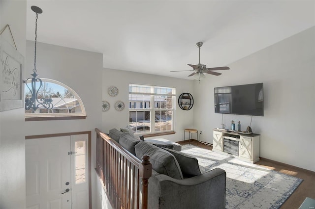 living room with ceiling fan, lofted ceiling, and hardwood / wood-style floors