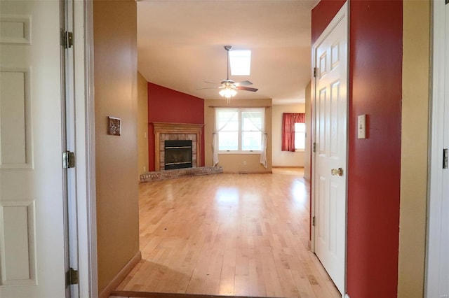 hall featuring light hardwood / wood-style flooring and lofted ceiling